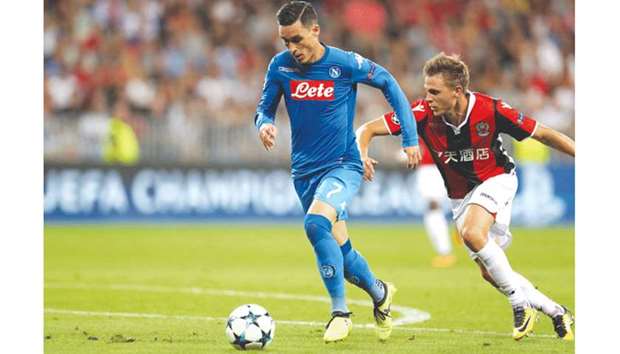Napoliu2019s Jose Maria Callejon (left) attempts tp get past Niceu2019s Arnaud Souquet during the Champions League play-off match at the Allianz Riviera stadium in Nice, southeastern France, on Tuesday. (AFP)