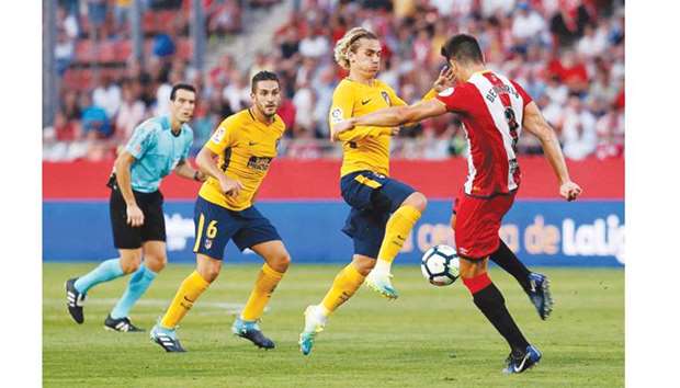 Atletico de Madridu2019s Antoine Griezmann (centre) was shown a straight red card against Gerona after insulting the referee for not awarding a penalty in his favour. (AFP)