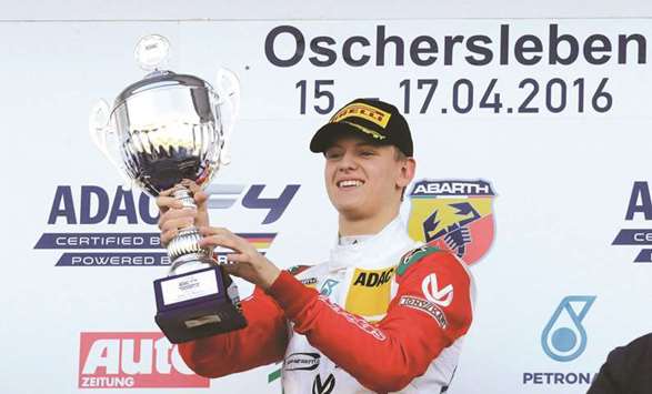 In this April 17, 2016, picture, Mick Schumacher of the Prema Powerteam celebrates on the podium after the ADAC Formula 4 GT Masters event in Oschersleben, Germany. (AFP)