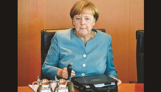 German Chancellor Angela Merkel awaits the start of the weekly cabinet meeting in Berlin, yesterday.