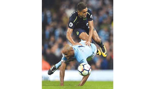 Manchester Cityu2019s Vincent Kompany goes down after a challenge from Evertonu2019s Dominic Calvert-Lewin during the English Premier League match. (AFP)