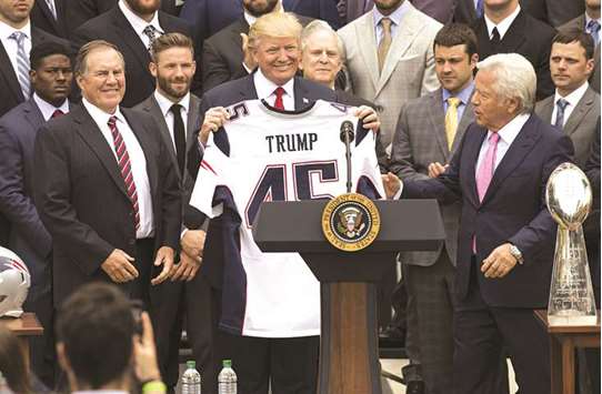 In this April 19, 2017, picture, US President Donald Trump holds a jersey given to him by New England Patriots owner Robert Kraft (right) during a ceremony honouring the 2017 Super Bowl Champions at the White House in Washington, DC. (AFP)