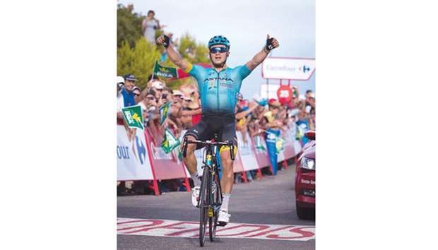 Astana rider Alexey Lutsenko celebrates as he crosses the finish line to win the fifth stage of the Vuelta a Espana in Alcoceber, Spain, yesterday. (AFP)