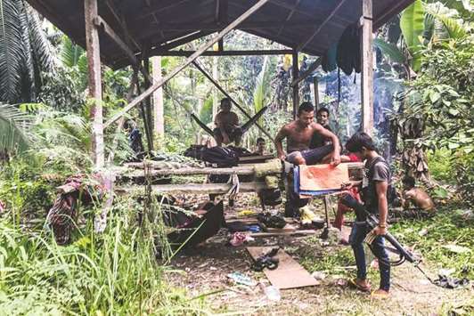 Members of the MILF in a makeshift wooden house near the frontline in Datu Salibo town.