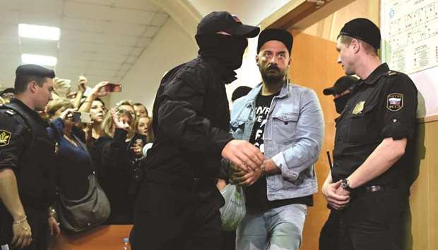 Serebrennikov, charged with fraud, is escorted by security officers ahead of a hearing at Moscowu2019s Basmanny district court.