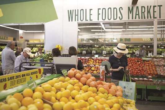 Customers shop for produce at a Whole Foods Market 365 location in Santa Monica, California. The US Federal Trade Commission said in a statement it would not pursue its investigation into the proposed acquisition of Whole Foods Market by Amazon further after reviewing whether the deal would substantially lessen competition or constituted an unfair method of competition.