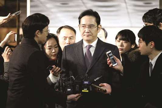 Samsung Group chief, Jay Y Lee, is surrounded by media as he arrives at the Central District Court in Seoul (file). A South Korean court will rule today on corruption charges against Lee, the billionaire head of Samsung, after a six-month trial in a nationwide bribery scandal that triggered the dismissal from office of the countryu2019s president.
