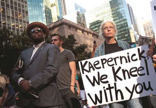 Activists rally in support of NFL quarterback Colin Kaepernick outside the offices of the  National Football League on Park Avenue in New York City.