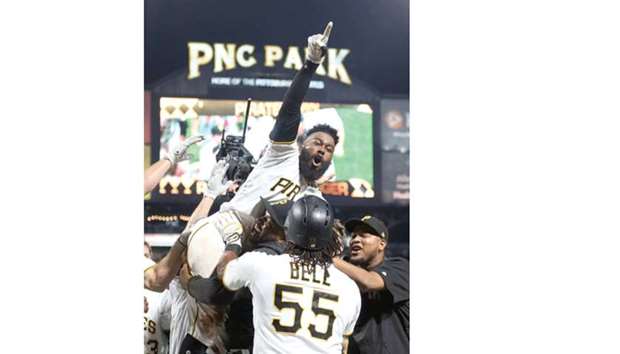 Pittsburgh Pirates second baseman Josh Harrison (5) celebrates with teammates after hitting a walk-off home run against the Los Angeles Dodgers during the tenth inning at PNC Park. Harrisonu2019s home run was the first Pirate hit of the game off Los Angeles Dodgers pitcher Rich Hill. Picture: Charles LeClaire-USA TODAY Sports