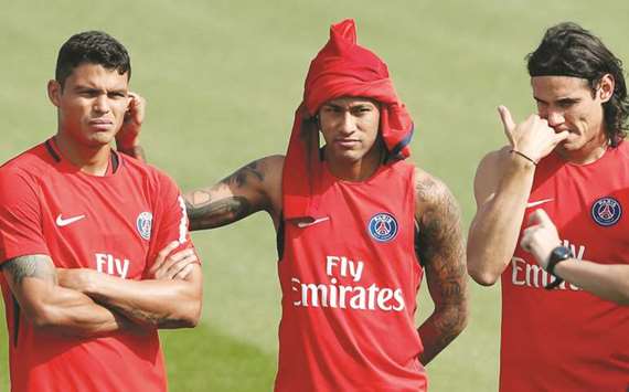 Paris St Germainu2019s Neymar (centre) with teammates Thiago Silva (left) and Edinson Cavani during a training session in Paris yesterday. (Reuters)