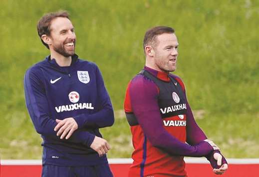 England interim manager Gareth Southgate (left) and Wayne Rooney. (Reuters)