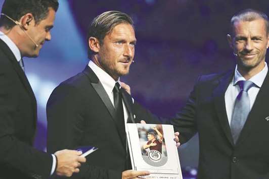 Romau2019s former player Francesco Totti is presented with UEFA President's award by UEFA President Aleksander Ceferin. (Reuters)