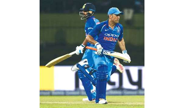 Indiau2019s batsman MS Dhoni (right) and Bhuvneshwar Kumar run between the wickets during the second ODI against Sri Lanka in Pallekele yesterday. (AFP)