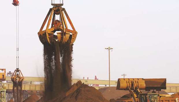 Cranes unload imported iron ore from a ship at a port in Rizhao, China. Iron ore has surged since mid-June on rising demand from China, with mills in the worldu2019s top user benefiting from rising product prices and strong profit margins.
