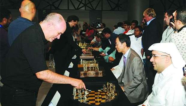 A grandmaster plays chess with QTA chief tourism development officer Hassan al-Ibrahim during the opening of the fourth World Mindsports Championships in Doha.