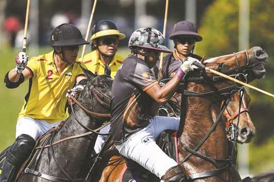 Bruneiu2019s Abdul Mateen Bolkiah (left) in action during the polo match against Malaysia in Putrajaya, outside Kuala Lumpur, on Tuesday. (AFP)