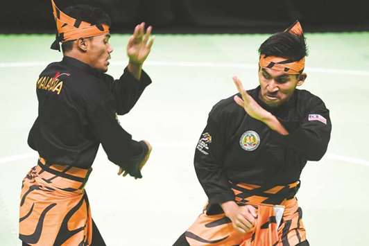 Mohamed Taqiyuddin bin Hamid and Rosli bin Mohamed Sharif of Malaysia in action during the Pencak Silat double final at the 29th Southeast Asian Games in Kuala Lumpur on Thursday. (AFP)