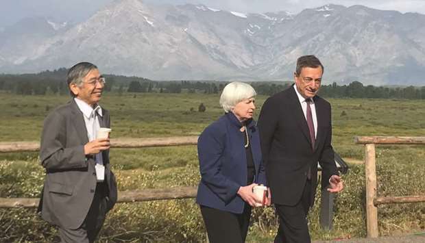 From left: Governor of the Bank of Japan Haruhiko Kuroda, Federal Reserve chair Janet Yellen and president of the European Central Bank Mario Draghi walk after posing for a photo opportunity during the annual central bank research conference in Jackson Hole, Wyoming, yesterday. Yellen said she and other current Fed members are not averse to revisiting how different regulations are working in practice, u201cand considering appropriate adjustments.u201d