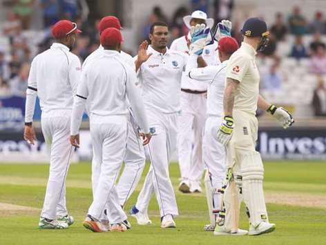 West Indies bowler Shannon Gabriel (C) celebrates with teammates after taking the wicket of Englandu2019s Ben Stokes (R) on the first day of their second Test match at Headingley cricket ground in Leeds yesterday.