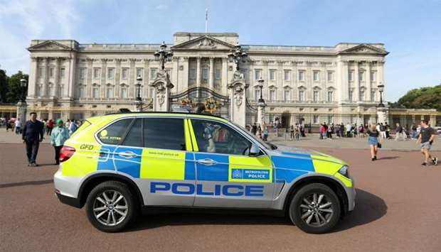 A police vehicle patrols outside Buckingham Palace in London