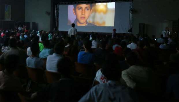 Palestinian families attending the screening of a movie