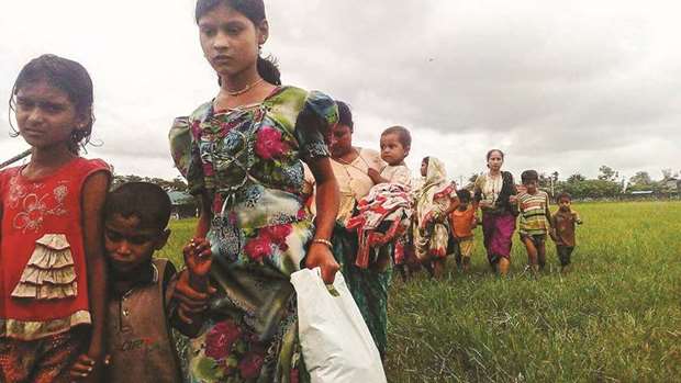 Women and children fleeing violence in their villages arrive at the Yathae Taung township in Rakhine State in Myanmar.