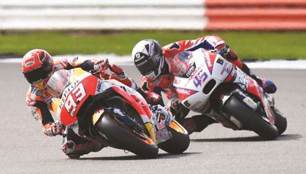 Honda's Marc Marquez (left) leads Pramac Racingu2019s Scott Redding during the qualifying session for British MotoGP at Silverstone circuit in Northamptonshire, southern England, yesterday. (AFP)