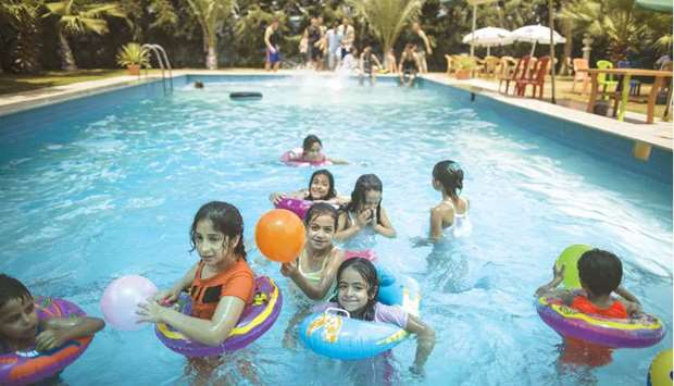 Palestinians cool off at a swimming pool in Gaza City.