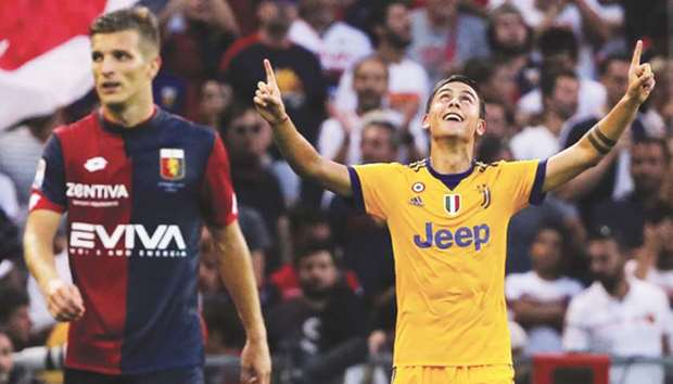 Juventusu2019 Paulo Dybala (right) celebrates after scoring against Genoa during their Serie A match in Genoa yesterday. (AFP)