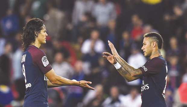 Paris Saint-Germainu2019s Neymar (right) congratulates teammate Edinson Cavani after the latter scored a goal during their Ligue 1 match against Saint-Etienne (ASSE) in Paris on Friday. (AFP)