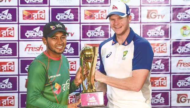 Australian cricket captain Steven Smith (R) and Bangladesh captain Mushfiqur Rahim (L) hold the tournament trophy at the Sher-e-Bangla National Cricket Stadium in Dhaka yesterday.