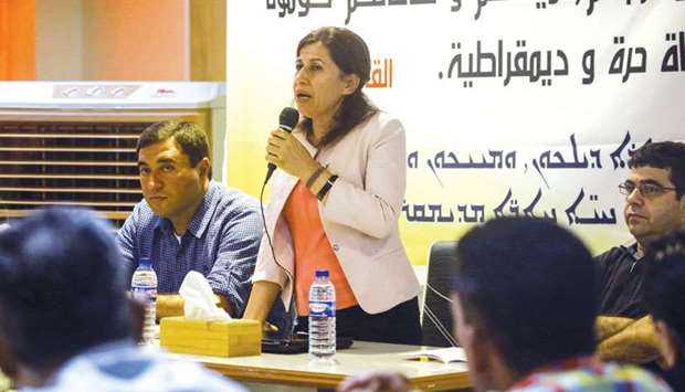 Hadiya Youssef, co-chair of the Syrian Kurdish federal systemu2019s constituent assembly, speaks during a summit in the northeastern Kurdish-majority Syrian city of Qamishli yesterday at a meeting bringing together Arabs, Syriacs and other parties to lay the groundwork for the first local elections.