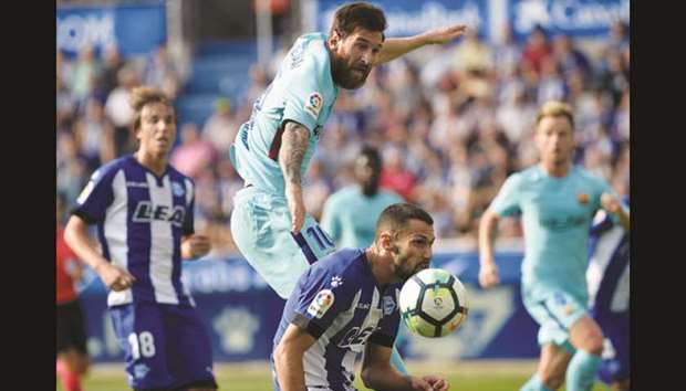 Barcelonau2019s Lionel Messi (top) in action against Deportivo Alaves during their La Liga match in Vitoria-Gasteiz, Spain, yesterday. (Reuters)