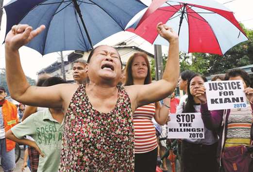 A woman, whose son was also shot in a drug-related killing, during the funeral march of Kian delos Santos.