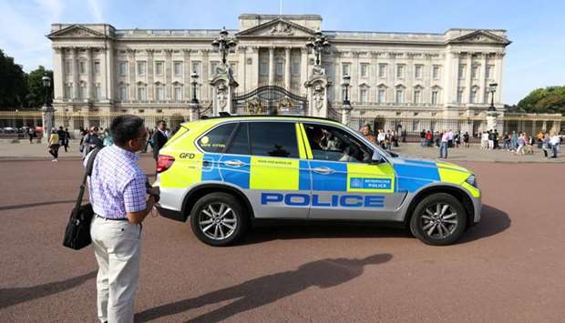 A police vehicle patrols outside Buckingham Palace in London
