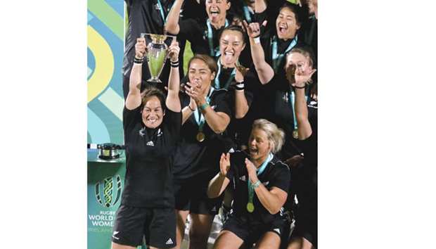 New Zealandu2019s captain Fiaou2019o Faamausili lifts the cup as her team celebrate their victory against England at The Kingspan Stadium in Belfast. New Zealand won the game 41-32.