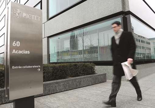 A man walks past the Pictet & Cie headquarters in Geneva. Pictet Asset Management experienced itu2019s worst year this decade last year as funds under management dropped about 25%.