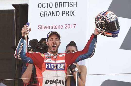 Ducati's Italian rider Andrea Dovizioso celebrates his victory at the Silverstone circuit. (AFP)