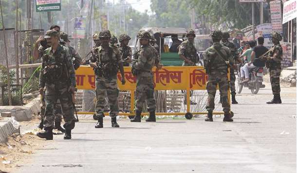 Soldiers stand guard at a barricade near the Dera Sacha Sauda headquarters in Sirsa yesterday.