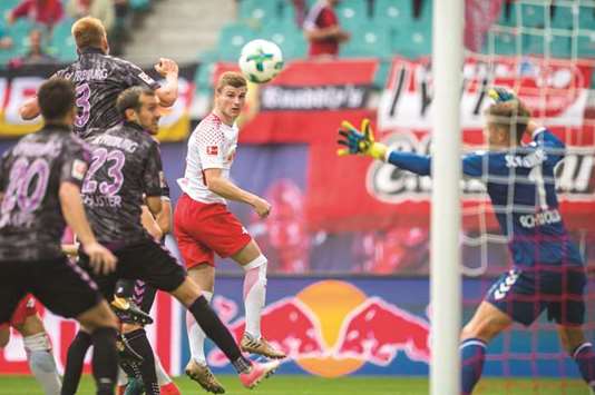 Leipzigu2019s forward Timo Werner (centre) scores against Freiburg during the Bundesliga match in Leipzig, eastern Germany. (AFP)