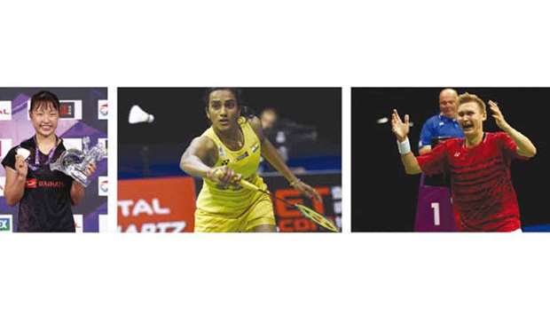 Japanu2019s Nozomi Okuhara displays her gold medal following her victory over Indiau2019s PV Sindhu (right) in the Badminton World Championships womenu2019s singles final in Glasgow yesterday. Right: Denmarku2019s Viktor Axelsen celebrates his win over Chinau2019s Lin Dan (not pictured) in the menu2019s singles final yesterday. (Reuters/AFP)
