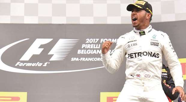 Mercedes driver Lewis Hamilton celebrates his Belgian Grand Prix win on the podium at the Spa-Francorchamps circuit yesterday. (AFP)