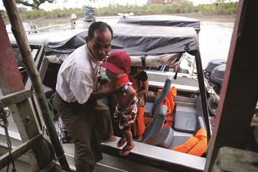 Local people flee from Maungdaw after Arakan Rohingya Salvation Army  attack, at Sittwe, Myanmar.