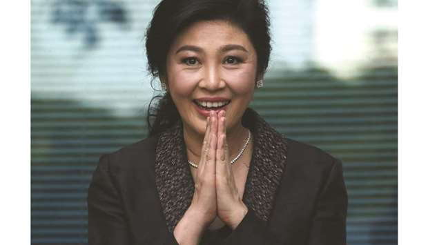 In this file picture, former Thai prime minister Yingluck Shinawatra greets supporters as she arrives at the Supreme Court in Bangkok.