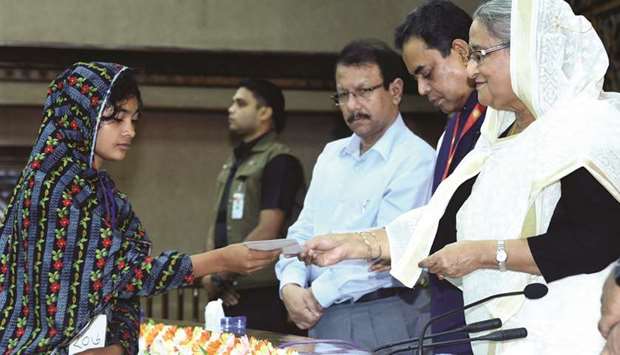 Hasina giving cheque to a garment worker yesterday.
