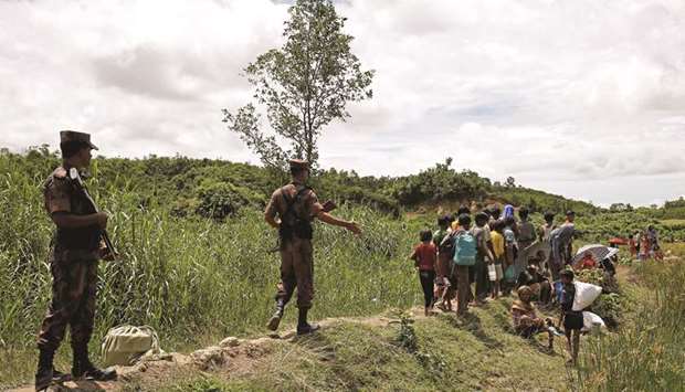 Members of Border Guard Bangladesh (BGB) push back Rohingya people who are trying to enter Bangladesh.