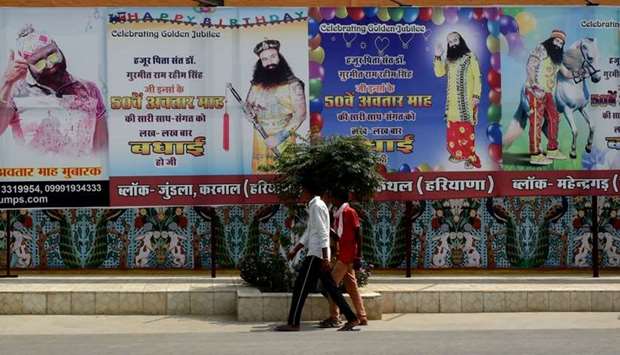Followers of the controversial Indian guru Ram Rahim Singh walk outside the 'Dera Sacha Sauda' ashram in Sirsa.