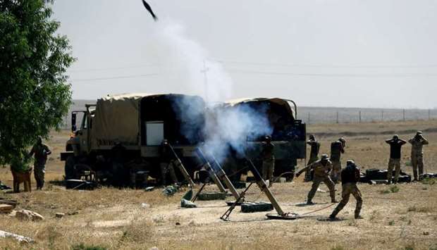 Members of Iraqi Army fire mortar shells during the war between Iraqi army and Shia Popular Mobilization Forces (PMF) against the Islamic State militants in al-Ayadiya, northwest of Tal Afar, Iraq