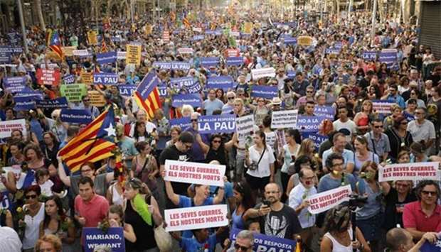 People hold placards during a march against terrorism in Barcelona on Saturday.
