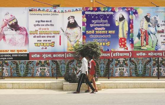 Followers of the controversial guru Ram Rahim Singh walk outside the Dera Sacha Sauda ashram in Sirsa.